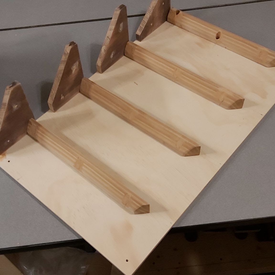 Plywood back with wooden shelf supports.